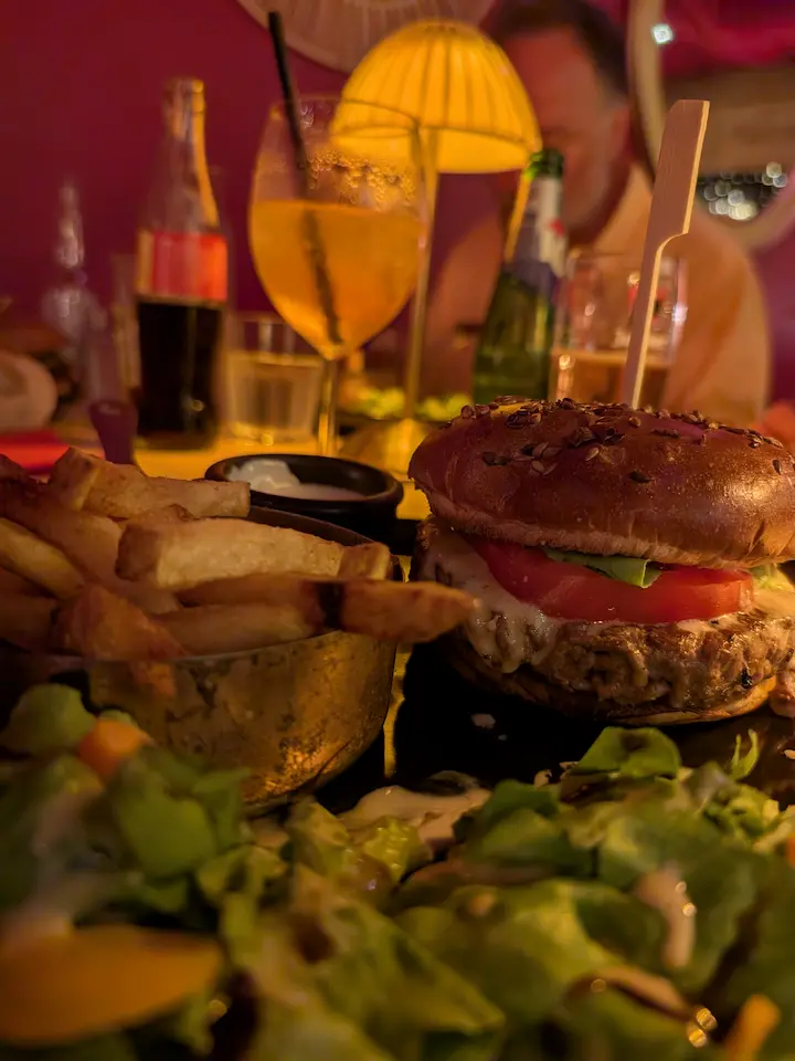 A burger with fries and salad